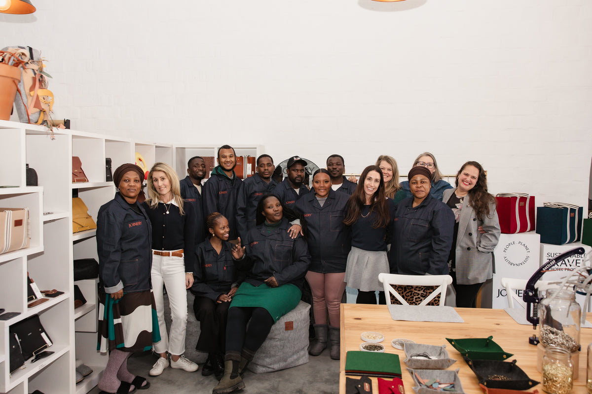 A small team, cutting and stitching every piece by hand.